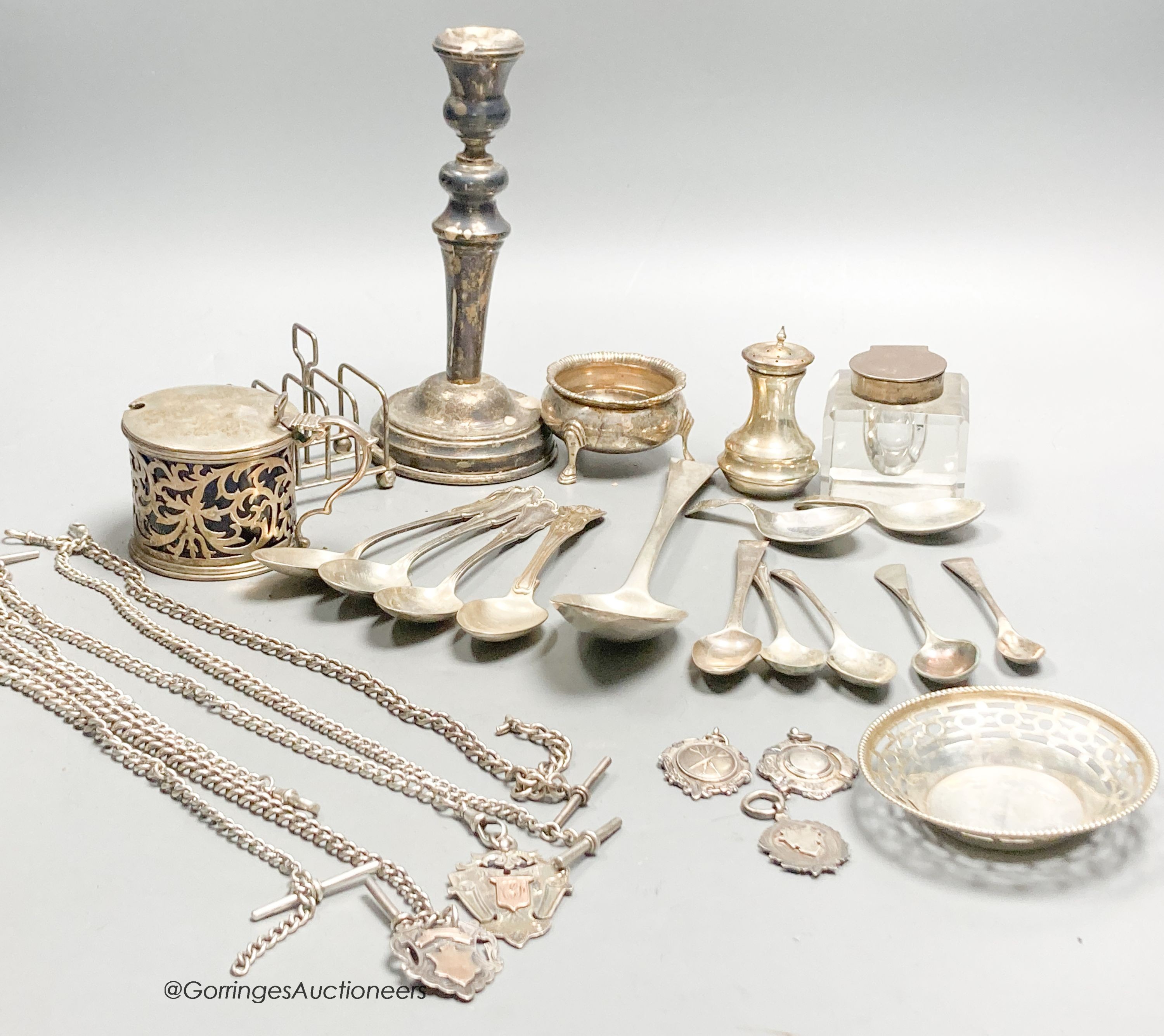 A collection of small silver, including a George V silver mustard, continental white metal and English silver flatware, toastrack, salt, inkwell etc. and a plated candlestick.